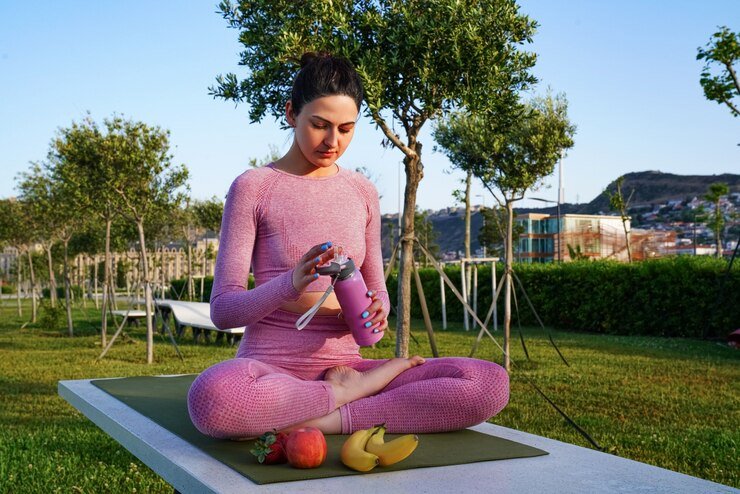 A woman practicing yoga in park